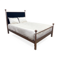 Olympus Iron Bed shown in Opaque Copper Finish with Black Velvet Performance Fabric. The Olympus bed is shown in angle view with silky luxurious cream bedding.