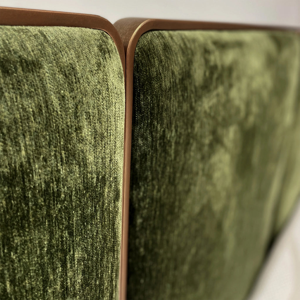 Close-up of the River bed headboard in Hand Brushed Copper Bliss Finish with Forest Green Fabric.